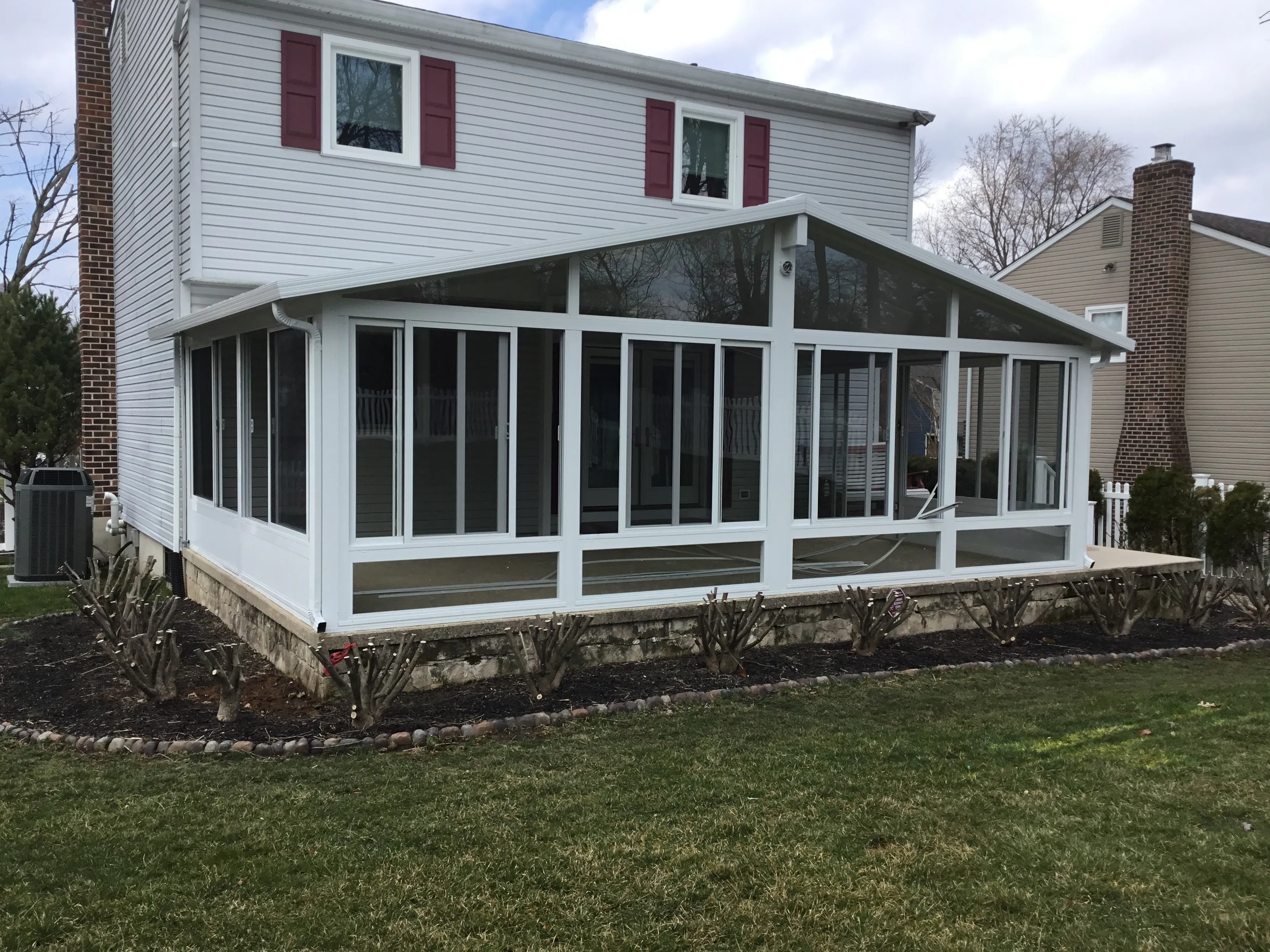 Gable roof sunroom on a two-storey colonial home