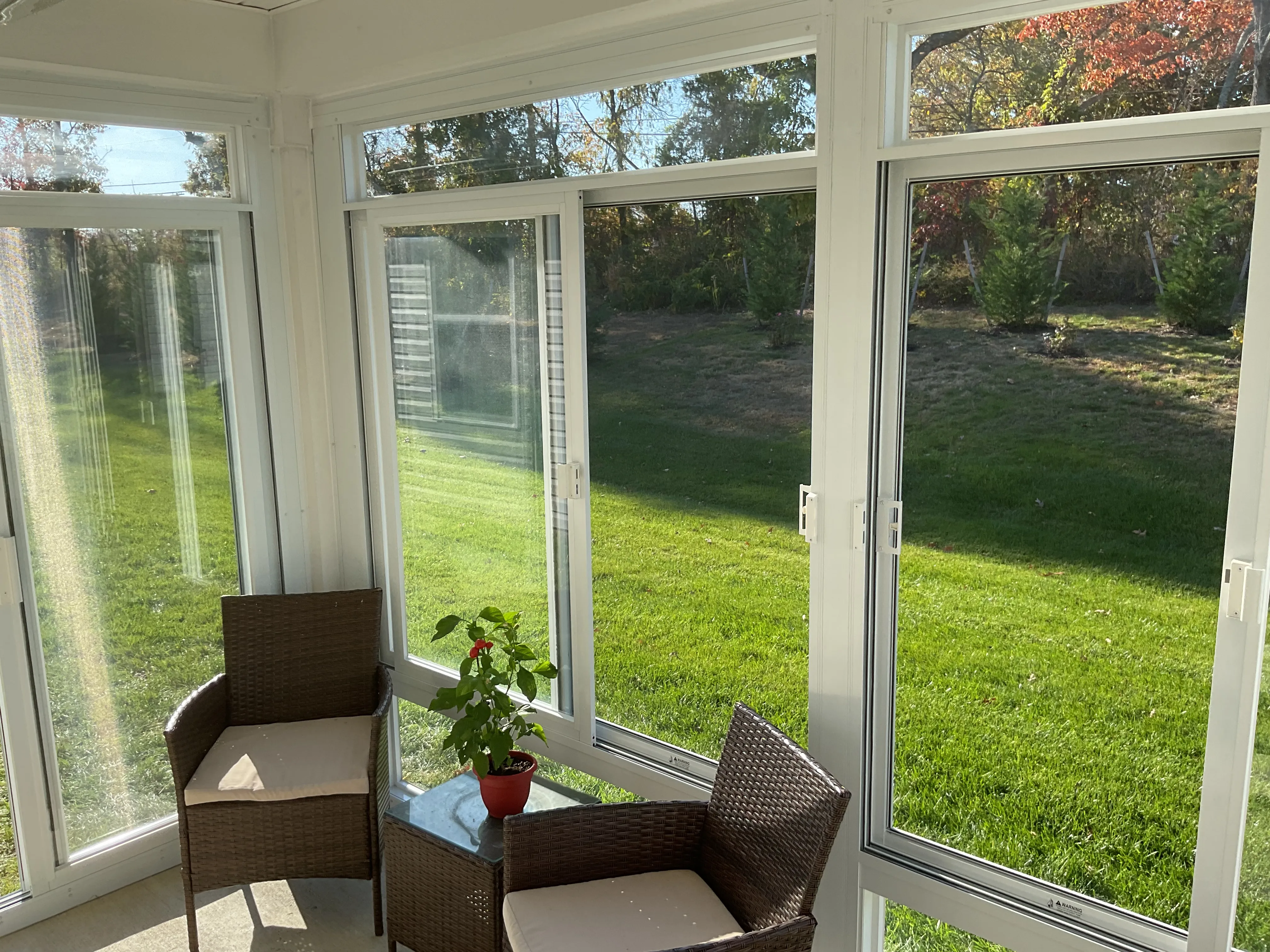 Inside a sunroom looking out across a lawn